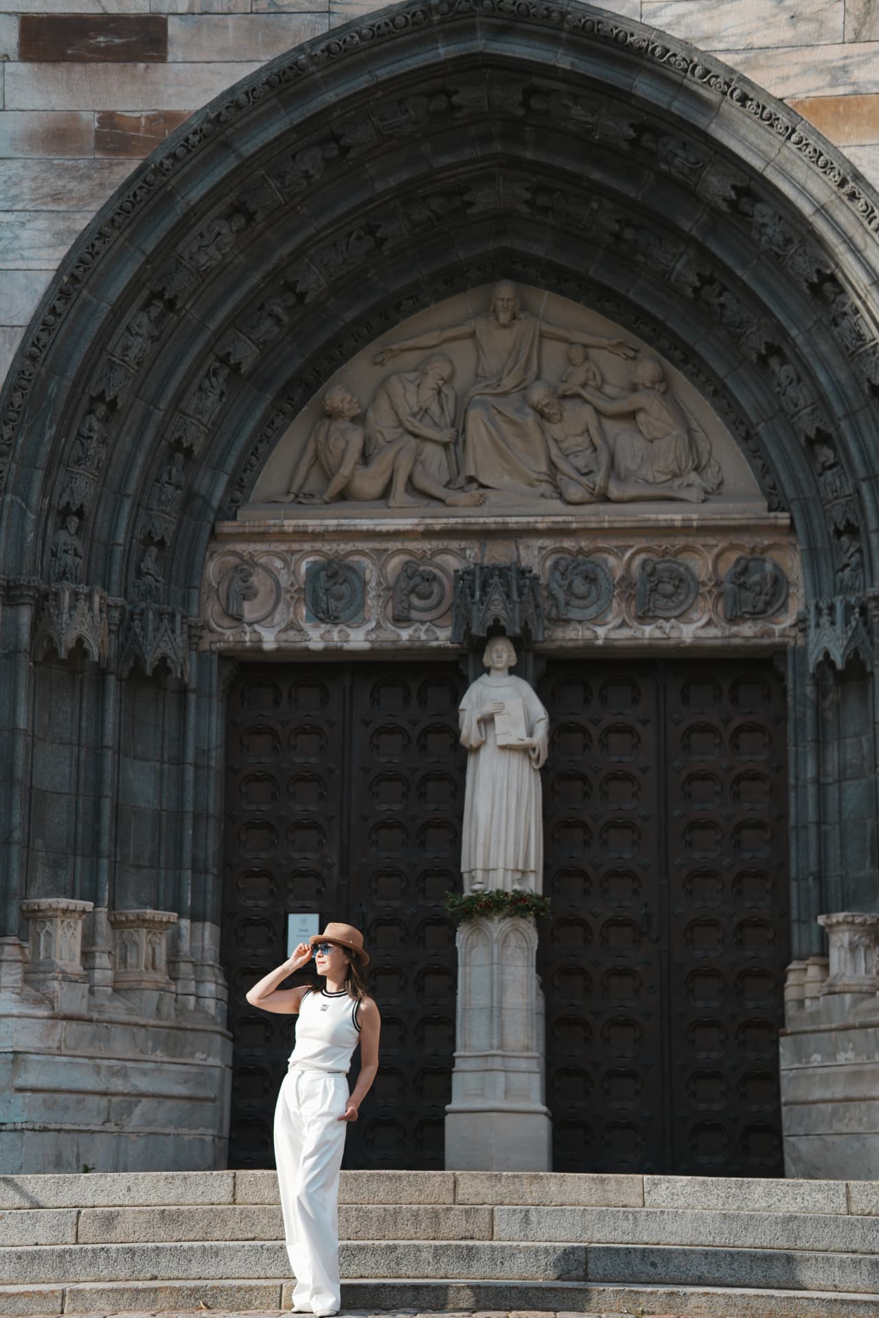 Woman in white on the steps of a Stockholm cathedral